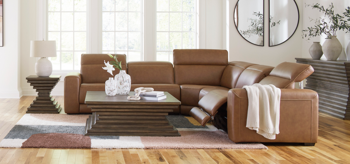 Brown leather sectional sofa in a living room setting with decor elements.